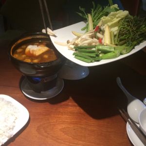 server adding veggies to our hot pot. no egg! at Hum Vegetarian - District 3 in Ho Chi Minh City