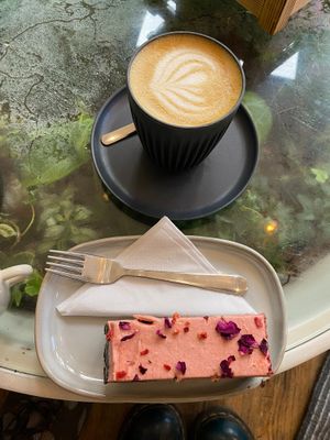 Oat milk latte and champagne truffle cake at Botanical Babe Plants in Llandudno
