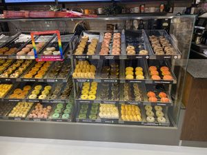 Vegan donuts has a little green sticker on them  at Dunkin' - Copenhagen Central Station in Copenhagen