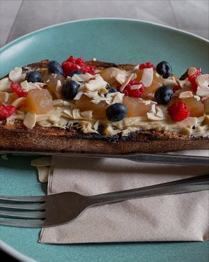 Sweet and savory on toasted sourdough - peanut butter - poached apples, fresh berries and almonds  at Mayvn in Edinburgh