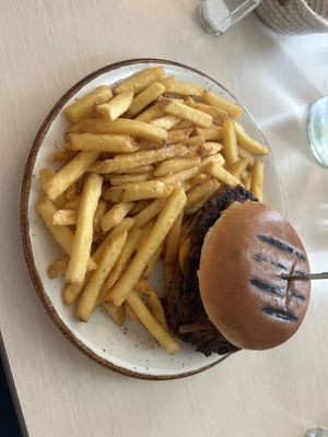 Smash burger- I think it was made with beyond or impossible . It had a cheese sauce that was delicious and the fries were crisp.  at Naustið in Husavik