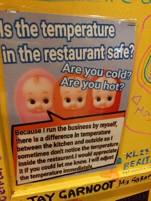 Cute signage on the walls at OKO Takoyaki in Osaka