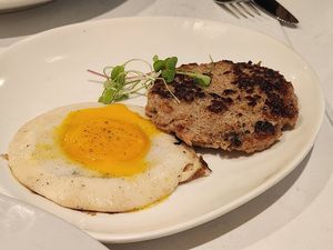 Sides of YoEgg sunny side up and sausage at Vibe Vegan Bistro in Destin