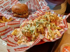 Prawns and french fries with chickn burger in the background at Thunder Vegan - La Latina  in Madrid