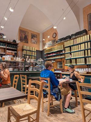 Tea canisters along the walls near the counter at Torteria Olsen in Turin