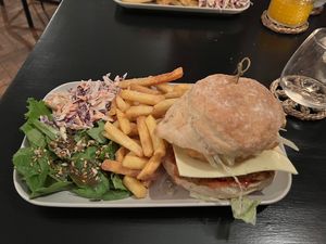 ‘KFM burger’ - fried chick’n style oyster mushroom, with hash brown and salad, served with coleslaw and side salad.  at Orange Cafe Bar in Mousehole