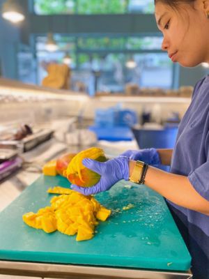 Preparing the fresh mango at Noa Poke Koukaki in Athens