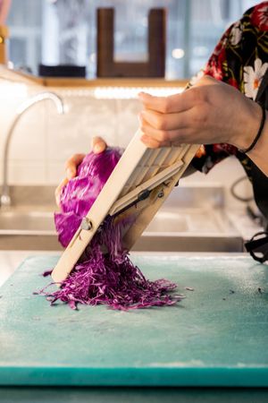 Preparing fresh red cabbage  at Noa Poke Koukaki in Athens