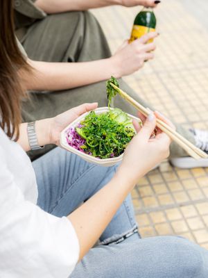 The staff enjoying a vegan lunch outside at Noa Poke Koukaki in Athens