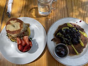 Breakfast sandwich and brunch menu’s lemon blueberry pancakes (half stack = one pancake) at Cleveland Vegan in Lakewood