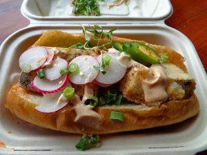 Banh Mi to go. This sandwich was huge!!! Very filling and flavorful. Marinated crispy tofu, kimchi, radish, jalapeno, greens, cilantro, scallion, French sandwich roll, chipotle mayo. at Cleveland Vegan in Lakewood