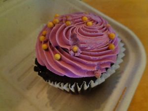 chocolate raspberry cupcake. moist cake, but the gold nonpareils were tough and I recommend picking them off and eating them separately and carefully. at Cleveland Vegan in Lakewood