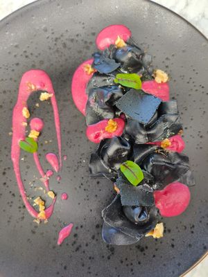 black cappellacci vegan goat cheese with beetroot cashew sauce at Plant Bistro in Ubud