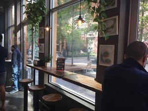Stools for sitting and eating; plus view of portion of park next door. at Bombay Sandwich Co. in New York City