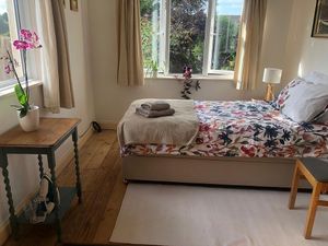 Bedroom, now floral look. Iron is proudly out on show.  at Kettering B&B in Kettering