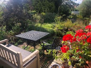 The area just to the right of the bedroom. In fine weather a choice place to sit and eat. Wifi reaches too, great for a scenic workplace. Cushions can be added for comfort. at Kettering B&B in Kettering