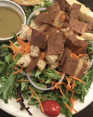 Large garden salad with sesame tahini dressing and Herbivorous Butcher bacon (personal fave).  at Pizza Luce - Lyndale Ave in Minneapolis