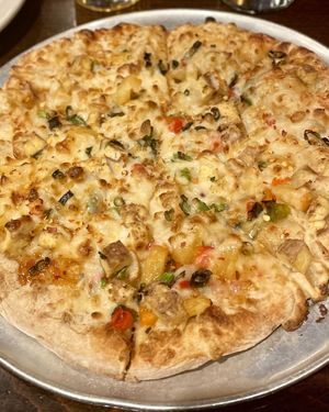 Vegan Fire Breathing Dragon pizza with sweet chili sauce, spicy Jerk tofu, pineapple salsa, green onion and vegan cheese 💚  at Pizza Luce - Lyndale Ave in Minneapolis