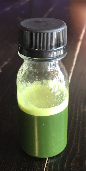 Shot of wheatgrass juice  at Sunrise Superfood Cafe in Wake Forest