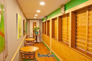 Side patio/art gallery with wood plantation shutter at Mead's Green Door Cafe in Orange