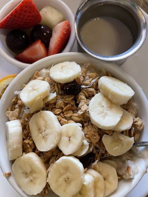 Hot oatmeal topped with bananas and homemade granola, fresh fruit and a side of oat milk  at Sage Biscuit Cafe in Bradenton