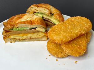 Smoked Tofurky Avocado Croissant + large hashbrowns (plated at home) at Dada's Plant-Based Burgers & Breakfast in Seattle