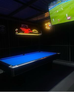 Playing pool in the cool breeze at Moonshine SVG in Arnos Vale