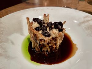 Salt crusted and aged celeriac, cherries, mushroom duxelle, herb oil and a cherry and coffee gravy  at Wolfs Junge in Hamburg