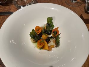 Walk through the forest in autumn: pumpkin prepared in different ways, kale, kalamata olive gel, kalamata olive crumble, cauliflower, herb oil  at Wolfs Junge in Hamburg