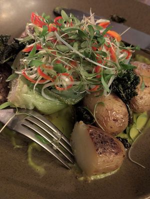 Garlic roast potatoes in pea & lemongrass sauce with bok choi, crispy kale and chilli & spring onion salad at York Minster Refectory in York