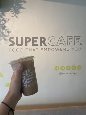 interior with vegan spanish latte  at SuperCafe PH  in Quezon City