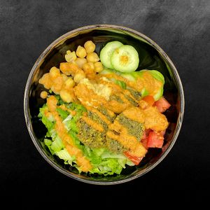 Mediterranean masterpiece featuring salad, cucumber, tomato, chickpeas, velvety hummus, and golden falafel. It's a burst of summer in every bite!  at Toss It in Phnom Penh