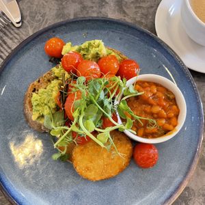 Vegan breakfast. Spicy baked beans, 2 hash browns. Avocado on toast with roasted cherry toms.   at An Talla in Inverness