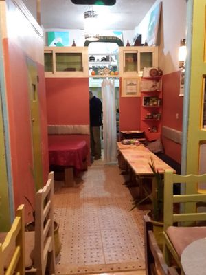 A tiny kitchen hides behind the pink walls. at Shyadma's Vegan Food in Essaouira