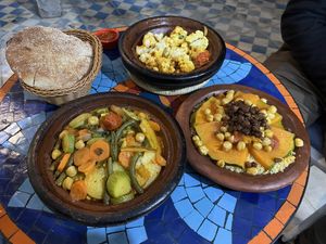 Vegetable tajine, cauliflower tajine half eaten already at this point, chickpea couscous with pumpkin and raisins    at Shyadma's Vegan Food in Essaouira