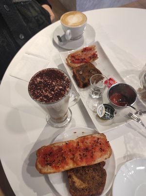 Café con leche, capuchino (taza larga), tostada con tomate y banana bread at Vibracafe in Valencia