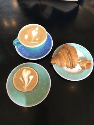 Latte, Flat white and plain croissant  at The Gallery Cafe in East London