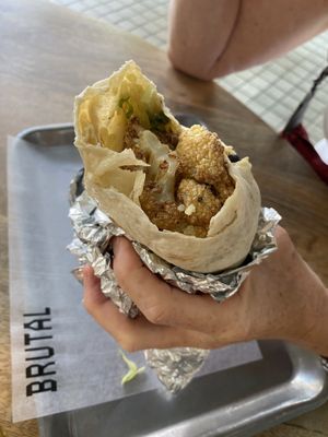 Vegan burrito with, green rice, black beans, roasted peppers, fried cauliflower and sauce   at Brutal Burrito in Madrid