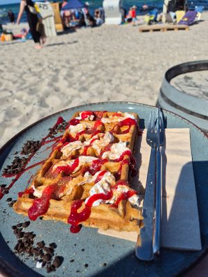Dish of the day. Waffles with cranberry sauce, cookie crumbles and vegan whipped cream. at Flunderbar in Hohwacht