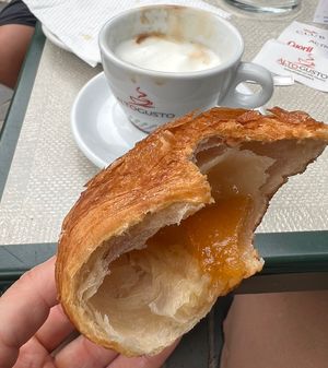 Soy cappucino and an apricot croissant almost gone.  at Bar Gelateria La Pineta in Dorgali