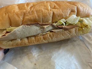 Prime roots cold cut trio sandwich from the case - ready to take to go for a picnic or enjoy in the cafe  at Timeless Coffee Roasters and Bakery in Oakland