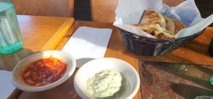 Pitas, with 2 vegan sauceson the left à spicy sauce and on the right a tahini sauce YUMMI at Abu Salim Middle Eastern Grill in San Francisco