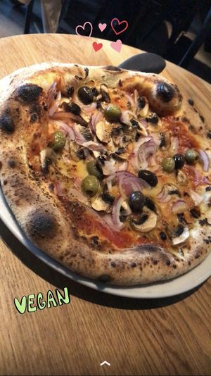 Amazing vegan pizza with Red onion, olives, mushrooms, garlic oil, oregano  at Grazie Tratttoria in Reykjavik