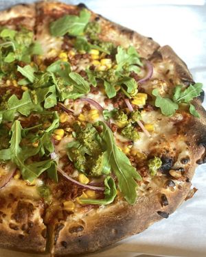 Yummy Gaucho pizza: Vegan Chorizo, Vegan Mozzarella, Toasted Corn, Red Onion, Arugula, Red Sauce, Chimichurri finish 💚  at Saint Paul Brewing in St Paul