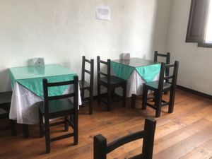 Inside. One of the rooms with tables   at Ricuras Integrales Luz in Manizales