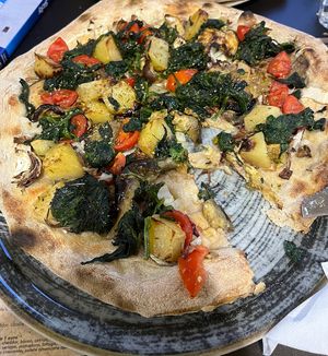 Delicious vegan pizzas with fresh veg including potatoes, spinach, tomatoes & fennel  at Terramadre Pizzeria Biologica in Catania
