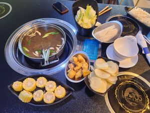 Mushroom broth and vegan ingredients (cabbage, tofu, potatoes, corn, glass noodles, etc.) at Lotus Hot Pot & Grill in Gladstone