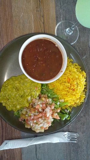Guac, pico de gallo, lettuce, yellow rice, pinto beans at Cilantro in St Georges
