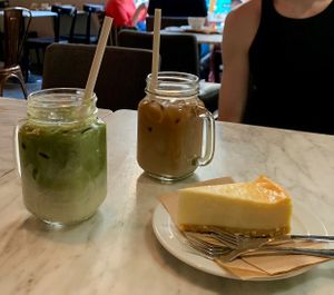 Vegan cheese cake with matcha latte & regular latte made with oat milk.   at Robert's Coffee in Helsinki