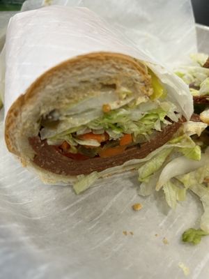 Half of a hot salami sandwich.  Extra napkins, please    at Vegan Deli and Butcher in St Louis